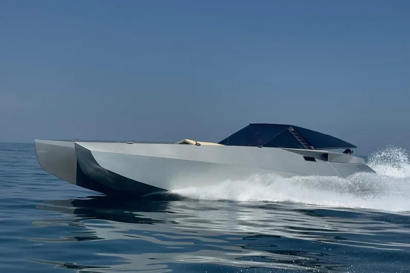 No Name Yacht Photos Pics Futuristic 2025 Offshore Racing Code X speedboat gliding on calm ocean waters.