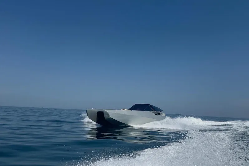 No Name Yacht Photos Pics 2025 Offshore Racing Code X speedboat cruising on open water under clear blue sky.
