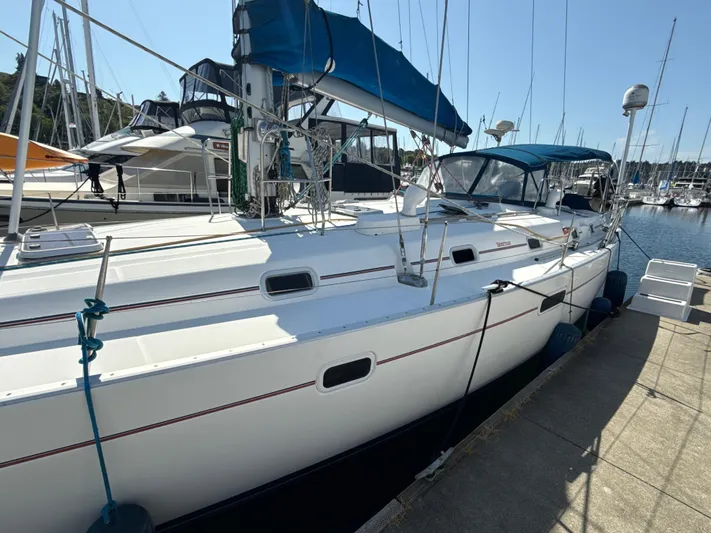 Gonzo Yacht Photos Pics Sailboat docked at marina, 1997 Beneteau 50 with blue canopy and white hull.