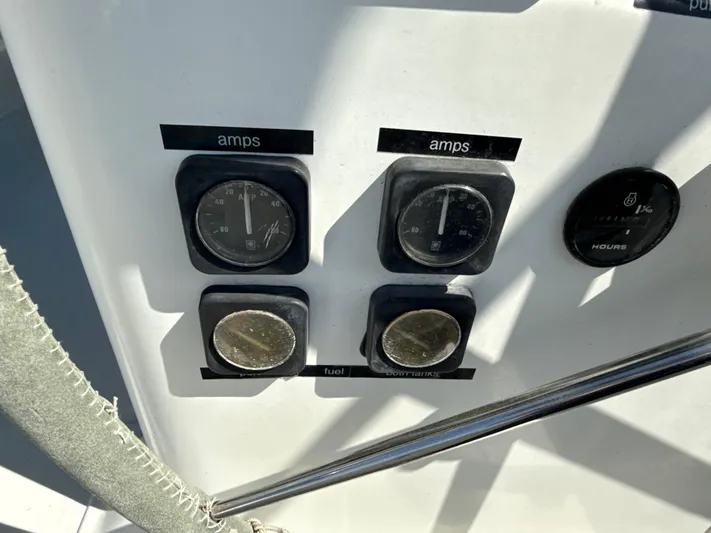 Gonzo Yacht Photos Pics Control panel of a 1997 Beneteau 50 yacht, displaying amp and fuel gauges.