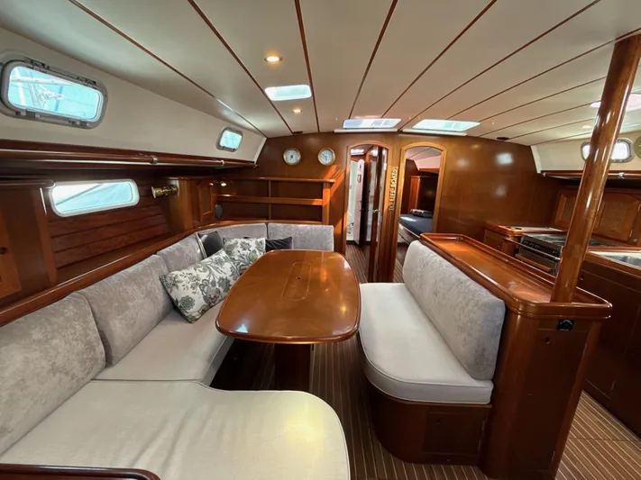 Gonzo Yacht Photos Pics Luxurious interior of a 1997 Beneteau 50 yacht with elegant wood finishes and cozy seating.