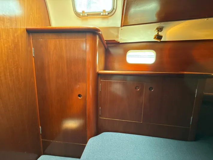 Gonzo Yacht Photos Pics Interior of 1997 Beneteau 50 yacht with wooden cabinetry and small window.