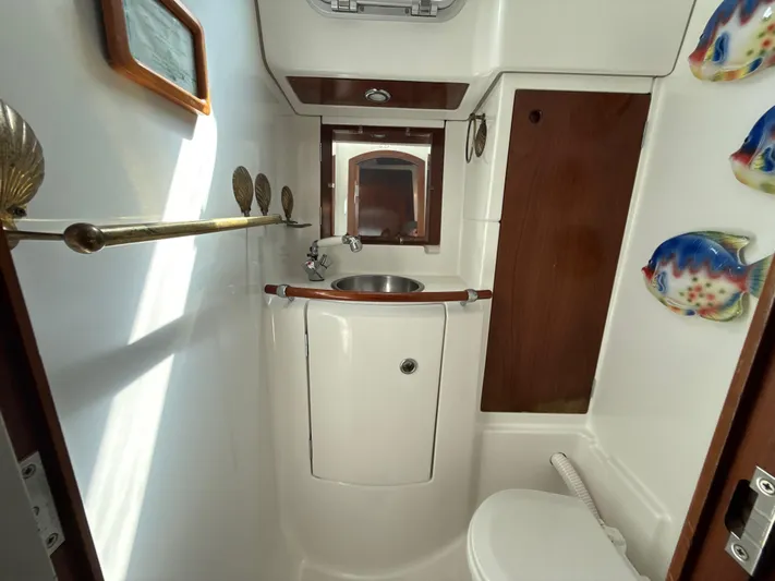 Gonzo Yacht Photos Pics Bathroom interior of a 1997 Beneteau 50 yacht with sink and nautical decor.