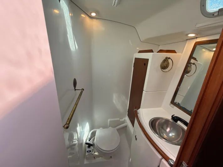 Gonzo Yacht Photos Pics Bathroom interior of a 1997 Beneteau 50 yacht, featuring a sink and toilet.