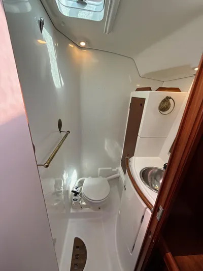 Gonzo Yacht Photos Pics 1997 Beneteau 50 yacht bathroom with toilet, sink, and skylight.