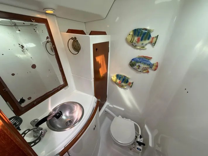 Gonzo Yacht Photos Pics Bathroom interior of 1997 Beneteau 50 yacht with fish decor and compact fixtures.