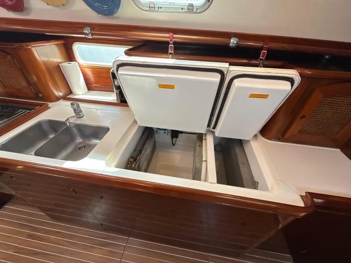 Gonzo Yacht Photos Pics 1997 Beneteau 50 yacht kitchen with double sink and open storage compartments.