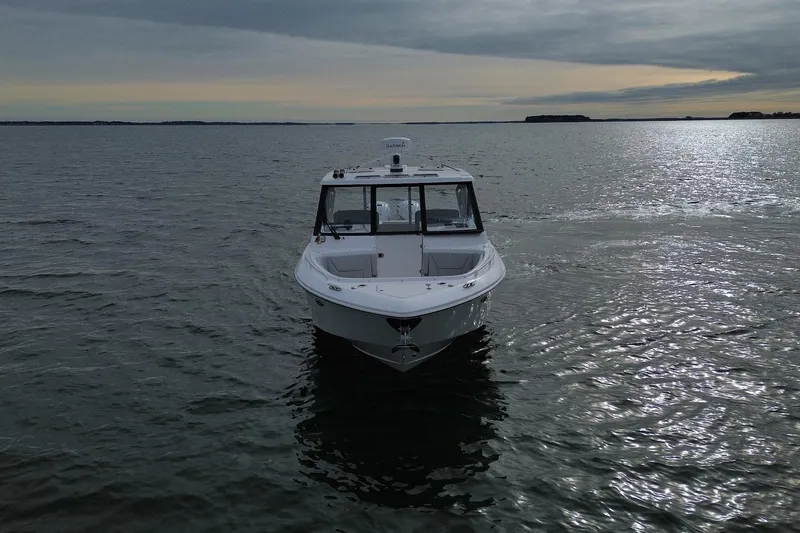 Untethered Yacht Photos Pics 2020 Everglades 340 Dual Console boat on calm water under cloudy sky.
