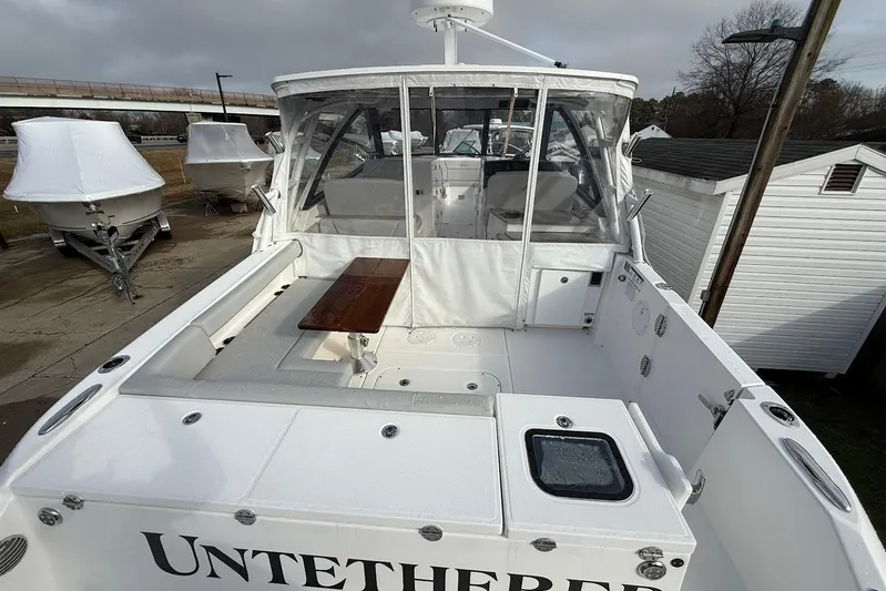 Untethered Yacht Photos Pics 2020 Everglades 340 Dual Console boat with covered seating and wooden table.