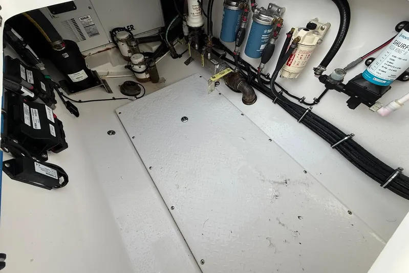 Untethered Yacht Photos Pics Engine compartment of a 2020 Everglades 340 Dual Console boat, showcasing wiring and components.