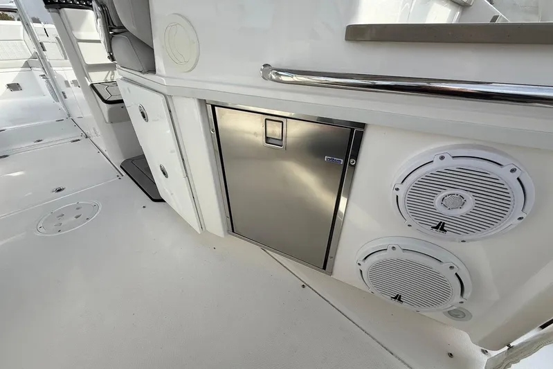Untethered Yacht Photos Pics 2020 Everglades 340 Dual Console boat interior with speakers and stainless steel fridge.