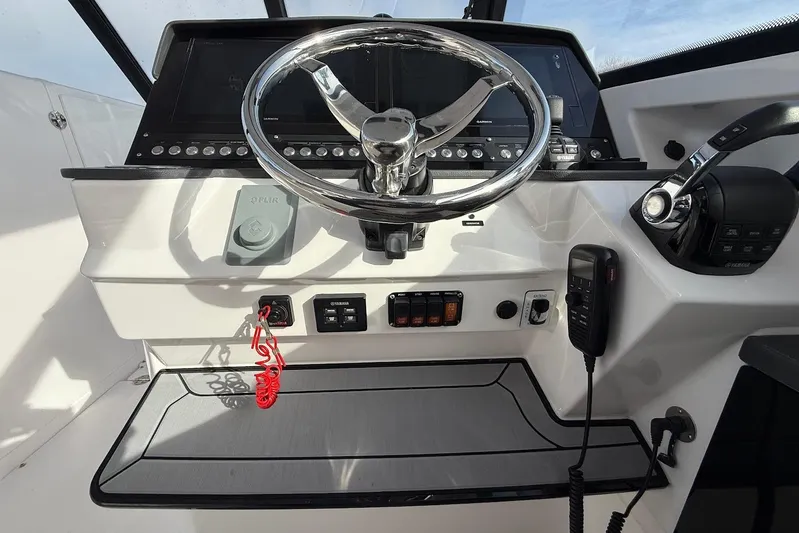 Untethered Yacht Photos Pics 2020 Everglades 340 Dual Console helm with steering wheel, controls, and navigation equipment.