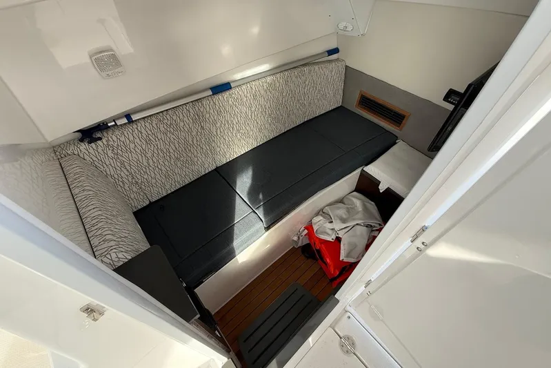 Untethered Yacht Photos Pics Interior cabin of 2020 Everglades 340 Dual Console boat, featuring seating and storage.