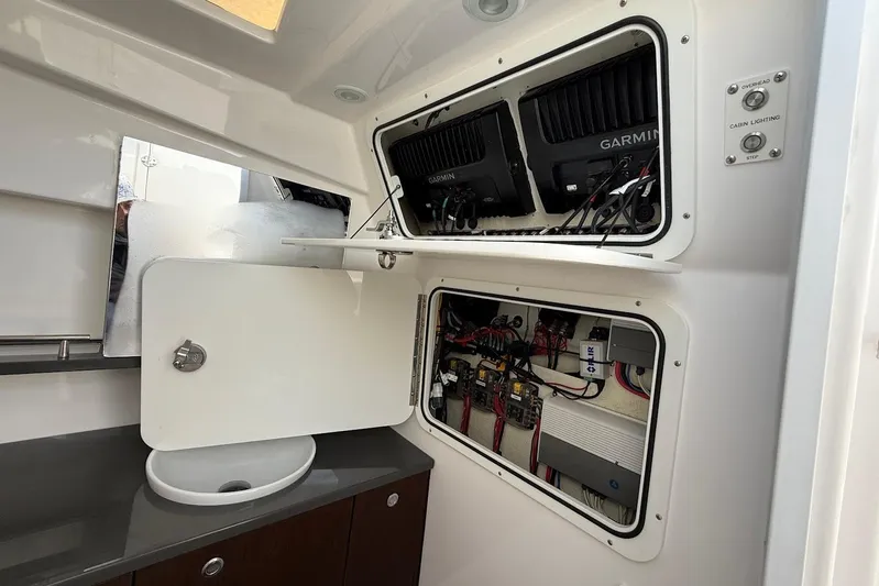 Untethered Yacht Photos Pics Interior view of 2020 Everglades 340 Dual Console boat's electrical panel and sink area.
