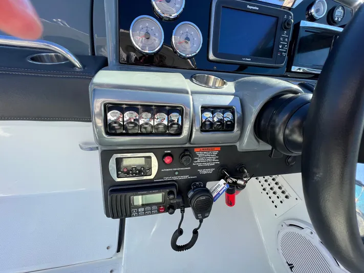  Yacht Photos Pics Control panel of a 2014 Formula 350 Crossover Bowrider boat with gauges and navigation equipment.
