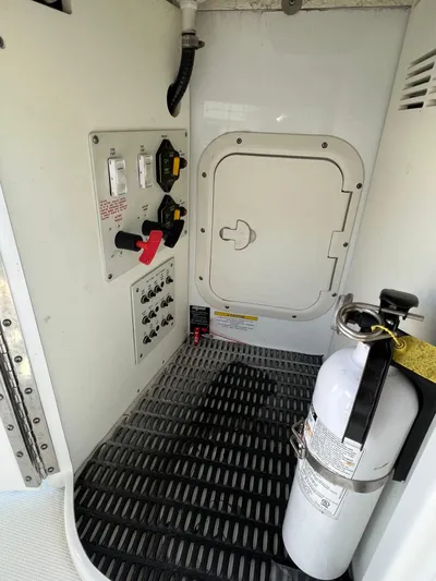  Yacht Photos Pics 2014 Formula 350 Crossover Bowrider engine room with control panel and fire extinguisher.