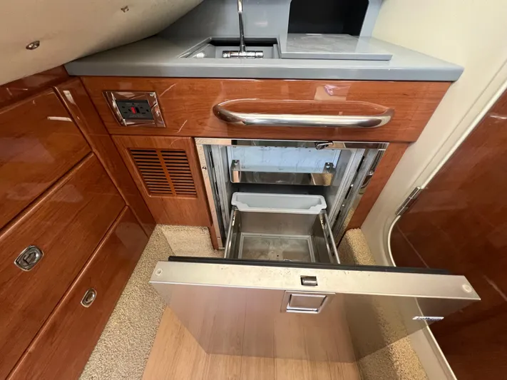  Yacht Photos Pics 2014 Formula 350 Crossover Bowrider interior kitchen with open drawer and sink.