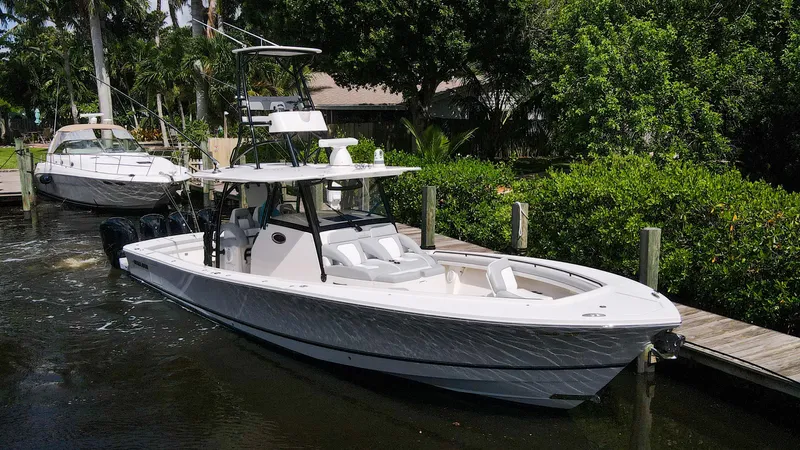 Grey Hull Yacht Photos Pics 2020 Regulator 41 boat docked in a marina with lush greenery.