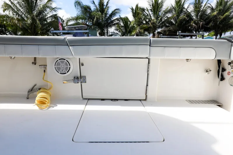 Grey Hull Yacht Photos Pics 2020 Regulator 41 boat deck with storage compartments and coiled hose.