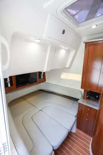 Grey Hull Yacht Photos Pics 2020 Regulator 41 boat cabin with leather seating and wooden cabinetry.