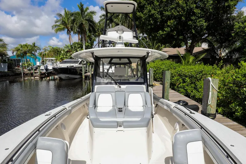Grey Hull Yacht Photos Pics 2020 Regulator 41 boat docked in a scenic marina with lush greenery.