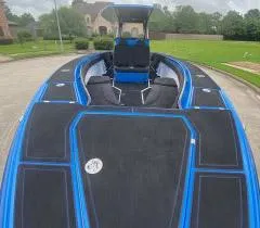  Yacht Photos Pics 2021 Statement 380 Open boat with sleek black and blue design on a residential street.