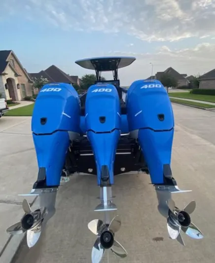  Yacht Photos Pics 2021 Statement 380 Open boat with triple 400 horsepower engines, parked in a residential area.