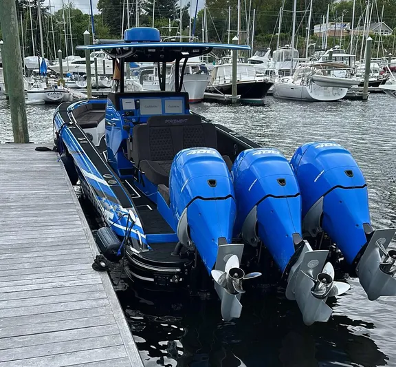  Yacht Photos Pics 2021 Statement 380 Open boat with triple blue outboard engines docked at marina.