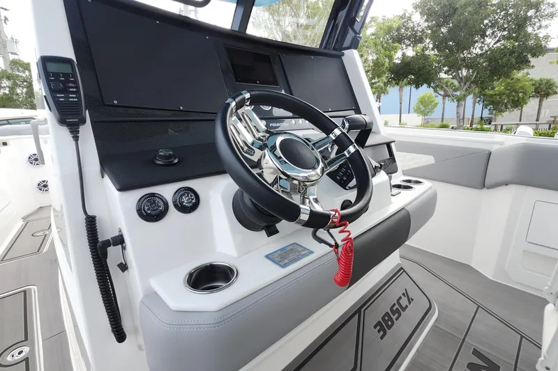  Yacht Photos Pics 2025 Fountain 38 SCX boat helm with modern steering and controls.