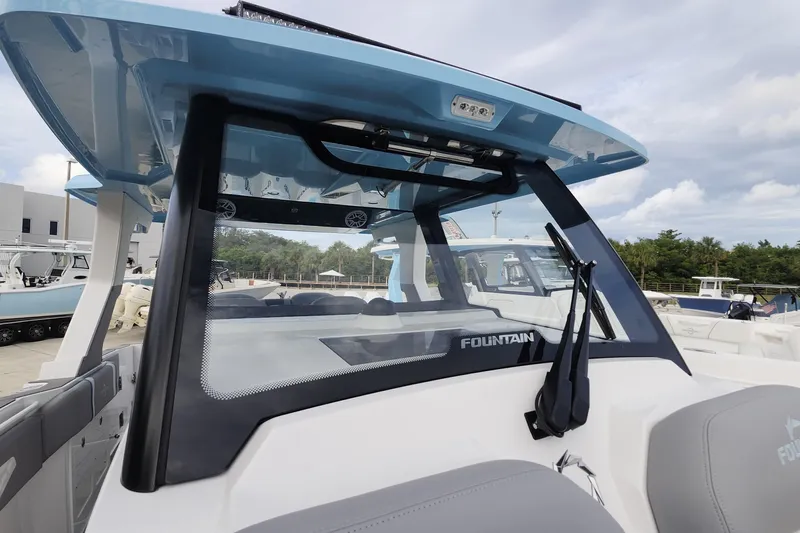  Yacht Photos Pics 2025 Fountain 38 SCX boat with sleek design and modern features, docked outdoors.