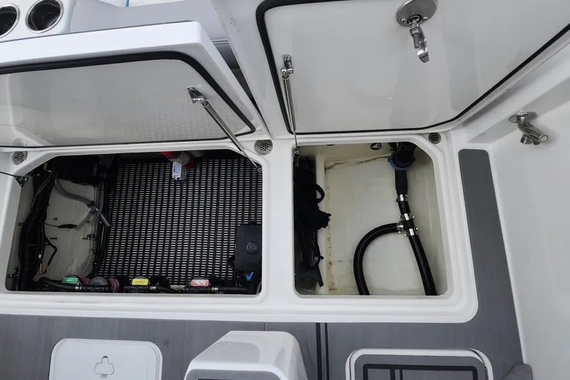  Yacht Photos Pics 2025 Fountain 38 SCX boat storage compartments with open hatches and visible equipment.