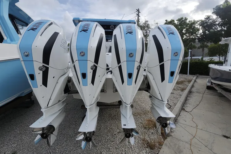  Yacht Photos Pics Four powerful outboard engines on a 2025 Fountain 38 SCX boat, parked outdoors.