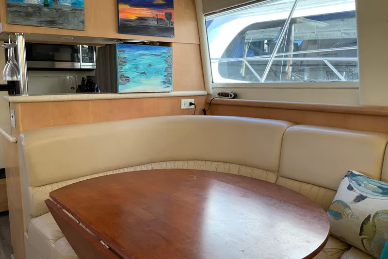 Sea Fox Yacht Photos Pics Interior of 1997 Carver 500 Cockpit Motor Yacht with dining area and artwork.