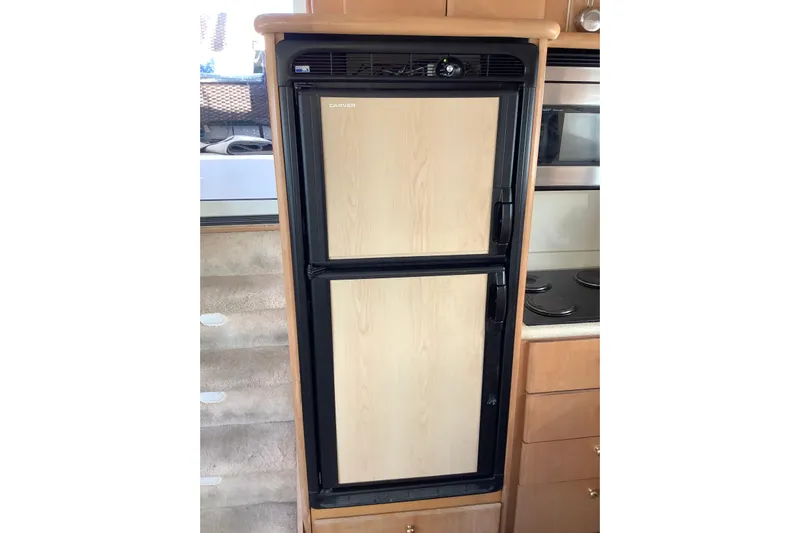 Sea Fox Yacht Photos Pics Built-in refrigerator in 1997 Carver 500 Cockpit Motor Yacht kitchen area.