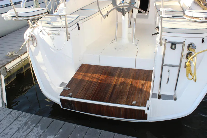 Yacht Photos Pics Hunter 33 sailboat stern with teak swim platform and ladder, docked at marina, 2014 model.
