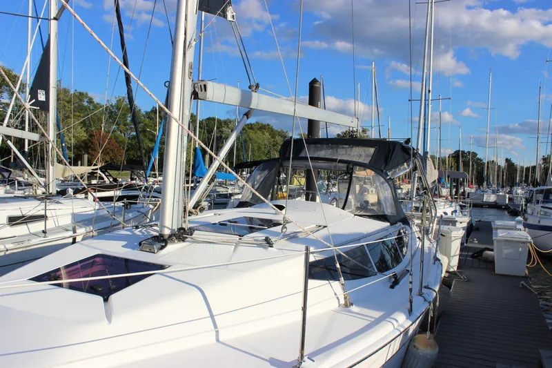  Yacht Photos Pics 2014 Hunter 33 sailboat docked at marina under blue sky.