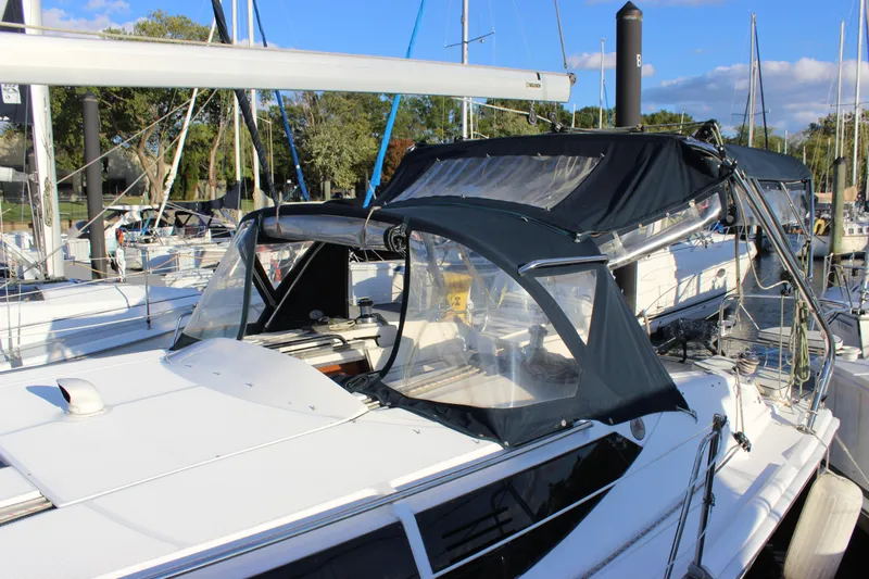  Yacht Photos Pics 2014 Hunter 33 sailboat docked at marina, featuring sleek design and protective canopy.