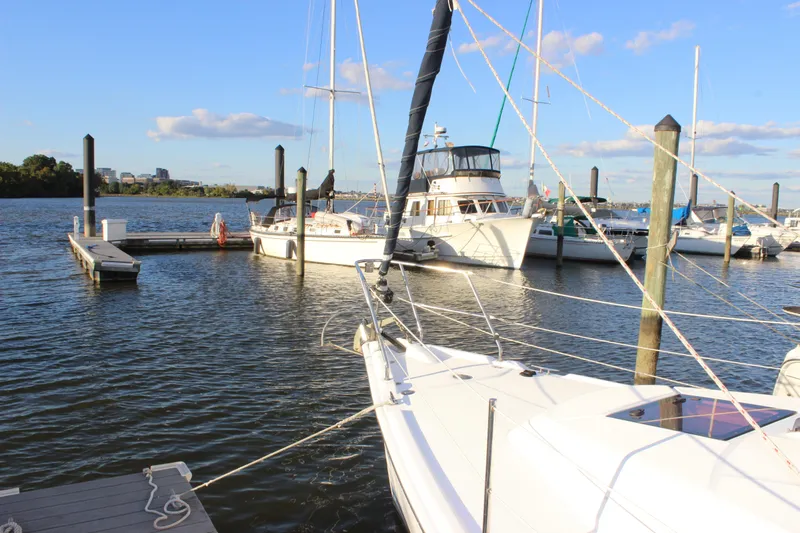  Yacht Photos Pics Sailboats docked at a marina, featuring a 2014 Hunter 33 model under a clear blue sky.