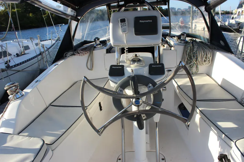  Yacht Photos Pics Cockpit of 2014 Hunter 33 sailboat with steering wheel and navigation equipment.