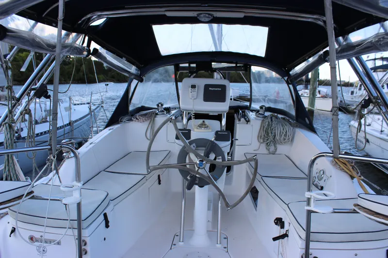  Yacht Photos Pics 2014 Hunter 33 sailboat cockpit with steering wheel, navigation equipment, and seating.