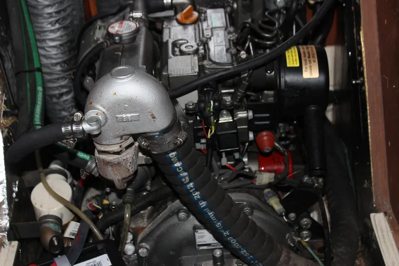  Yacht Photos Pics Engine compartment of a 2014 Hunter 33 sailboat, showcasing mechanical components and hoses.