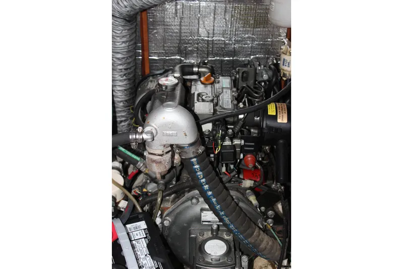  Yacht Photos Pics Engine compartment of a 2014 Hunter 33 sailboat, showcasing mechanical components and hoses.