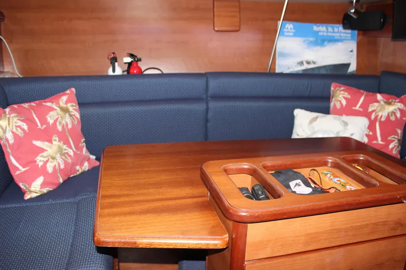  Yacht Photos Pics Interior of 2014 Hunter 33 sailboat with wooden table and blue seating.