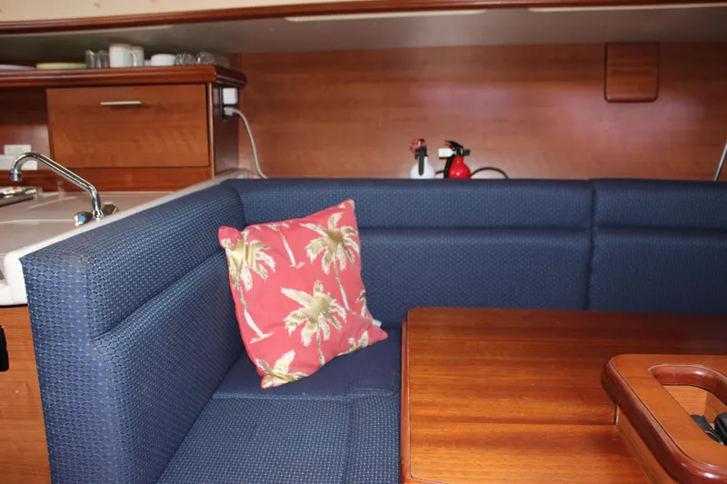  Yacht Photos Pics Interior of 2014 Hunter 33 sailboat with blue seating and tropical pillow.
