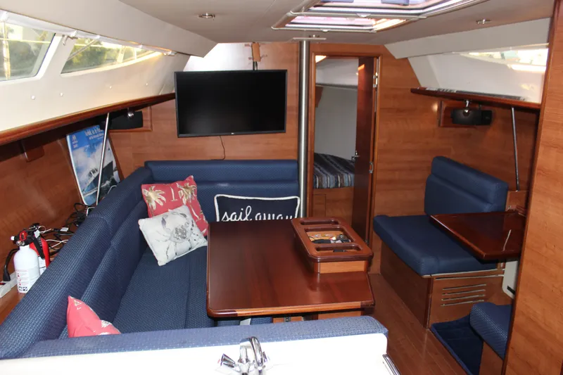  Yacht Photos Pics Interior of a 2014 Hunter 33 sailboat with cozy seating and wooden finishes.