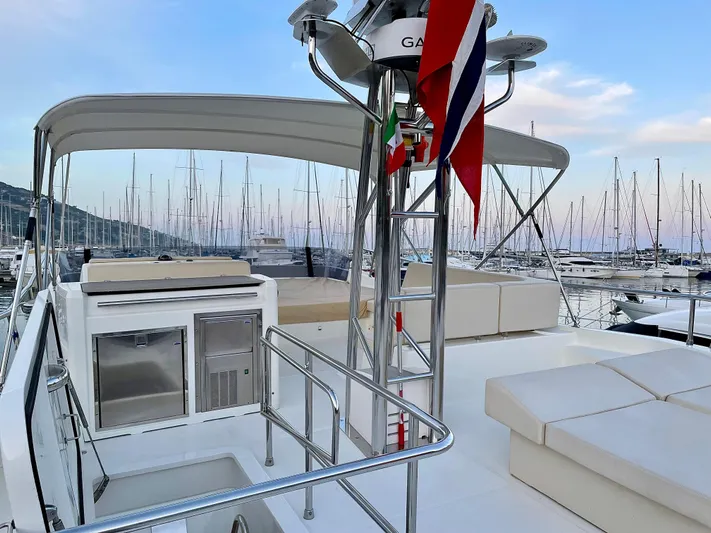  Yacht Photos Pics 2016 Cranchi Eco Trawler 53 Long Distance yacht deck with seating and marina view.