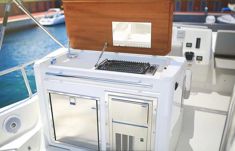  Yacht Photos Pics Outdoor kitchen on 2016 Cranchi Eco Trawler 53 Long Distance yacht, featuring grill and storage.