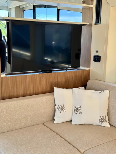  Yacht Photos Pics Interior of 2016 Cranchi Eco Trawler 53 with TV and cozy seating area.
