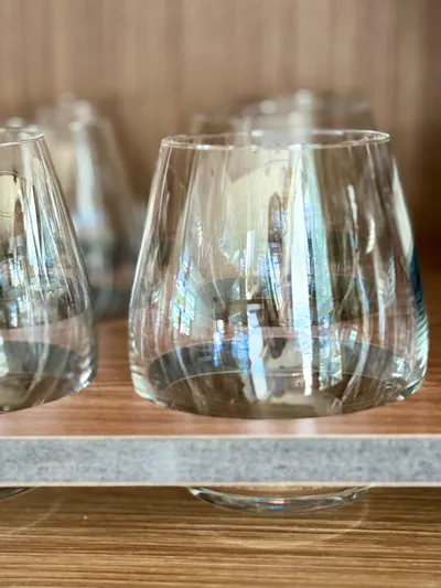  Yacht Photos Pics Close-up of elegant glassware on a wooden shelf, reflecting light beautifully.