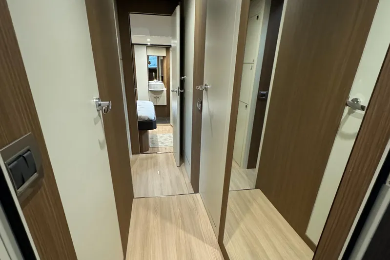  Yacht Photos Pics Interior hallway of 2016 Cranchi Eco Trawler 53 Long Distance yacht, featuring modern wood finishes.